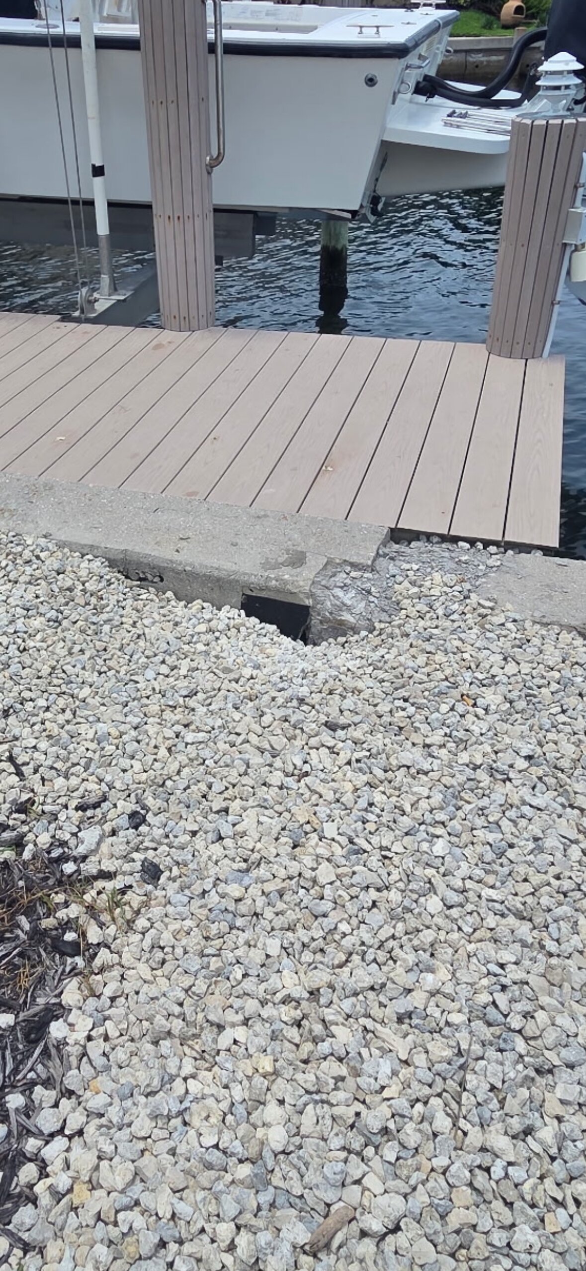 Catching it early is everything. A small dip in the drain now is a full seawall failure later — the actual crack is underwater, but this is how you spot it from land.
