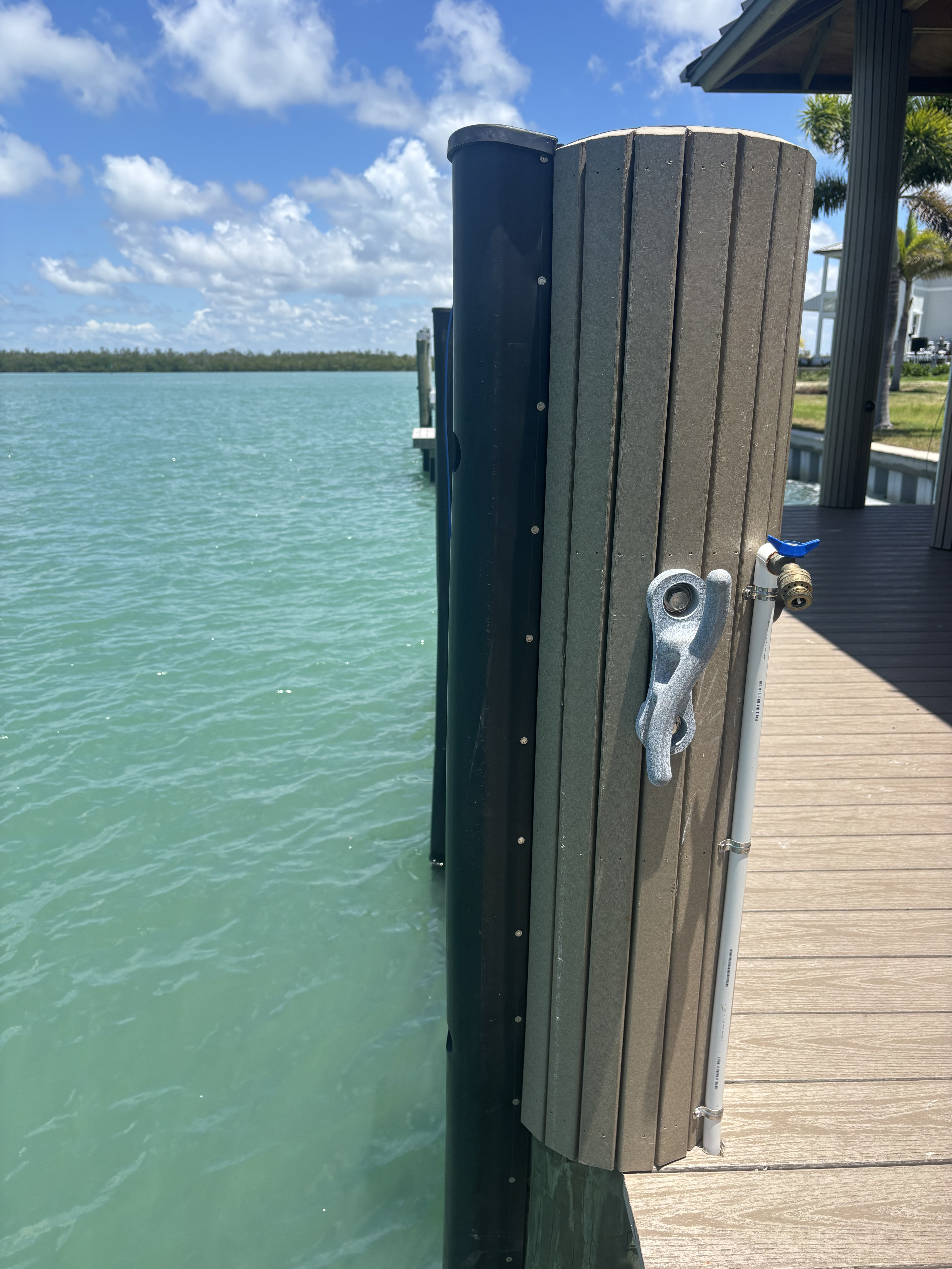 Dock bumper with built-in cleat and hose bib — tie off, wash down and protect the piling all in one spot.